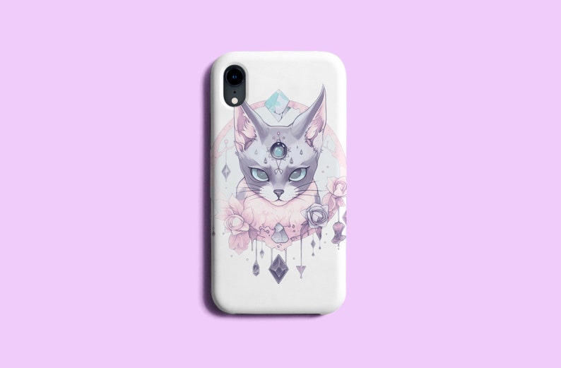 May include: White phone case featuring a design of a grey cat with a third eye and a floral pattern in pink and purple.