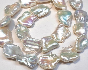 May include: A strand of white baroque pearls with iridescent hues. The pearls are irregular in shape and have a smooth, polished finish.
