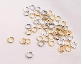 May include: A pile of small, gold and silver jump rings. The rings are about 5mm in diameter and are perfect for jewelry making.