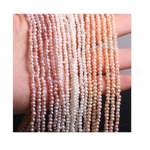 May include: A strand of small, white, pink, and peach freshwater pearls. The pearls are strung on a thin thread and are approximately 3-4 mm in diameter.