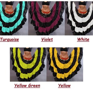 May include: Five different colors of a layered dance skirt. The skirt is black with a layer of turquoise, violet, white, yellow green, and yellow fabric. The skirt is worn by a person with a black top and a gold belt.
