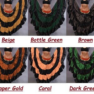 May include: Six different colors of a layered, ruffled dance skirt. The skirt is black with a contrasting color on the bottom layer. The colors are beige, bottle green, brown, copper gold, coral, and dark green.