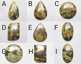 May include: Nine polished gemstones in various shapes, including teardrop, oval, round, and rectangular. The stones display olive green, brown, and black patterns. Each stone has a unique pattern, ideal for jewellery making or collecting.