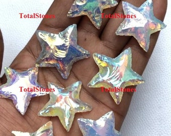 May include: Seven iridescent white star-shaped crystal points with a rainbow sheen. The crystals are arranged on a hand.