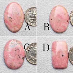 May include: Four polished rhodochrosite gemstones in various shapes, each with a quarter coin for size comparison. The stones display a range of pink hues with darker speckling. The shapes include oval and rectangular.