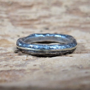 Cast silver wedding ring with gold insert