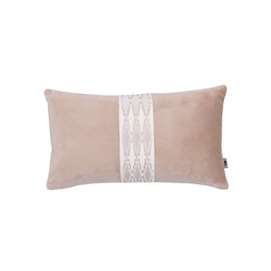 May include: A blush pink velvet pillow with a white embroidered geometric pattern down the center.