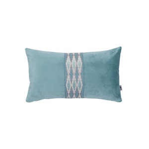 May include: A light blue rectangular cushion with a decorative embroidered band in shades of blue, white, and pink.