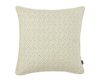 May include: A green and white patterned throw pillow with a cream colored border.