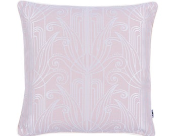 May include: A pink throw pillow with a white geometric pattern. The pillow has a white border.
