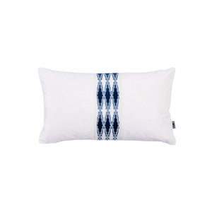 May include: White rectangular cushion with a blue and white geometric pattern down the centre.