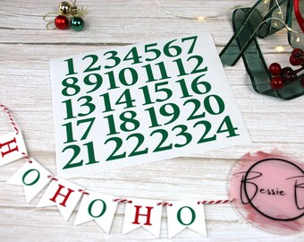 May include: A set of green numbers 1 through 24 on a white background. A banner with the text "HO HO HO" is in the foreground.