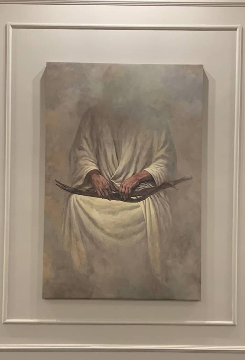 May include: A painting depicting a figure in a white robe seated with their hands clasped around a long, thin object. The background is a light grey with a cloudy effect.