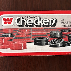 May include: A vintage Crown Checkers game box with red and black checkers pieces. The box is red with white and black text, including the Whitman logo. The game includes 24 plastic pieces.