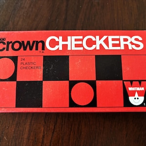 May include: A red and black checkerboard game box with the words "crown CHECKERS" in white. The box also features the text "24 PLASTIC CHECKERS" and the Whitman logo.