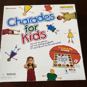 May include: A colorful game box for Charades for Kids. The box features illustrations of children acting out different charades. The game includes two levels of play, including a no reading required version.