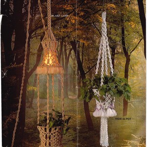 May include: Two macrame plant hangers. One is a plant lamp with a light inside, the other is a hide-a-pot. Both are suspended from a rope. The plant lamp is beige with a light inside. The hide-a-pot is white with a plant inside.
