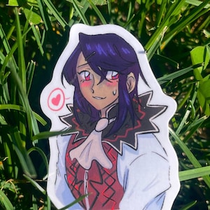 May include: A sticker featuring a cartoon character with purple hair, wearing a white shirt with a red and black vest. The character has a blush on their cheeks and a heart-shaped speech bubble above their head.