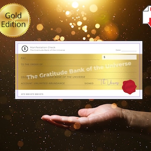 May include: A gold-colored "Manifestation Check" from "The Gratitude Bank of the Universe" with a red seal and the signature "The Universe." The check has a gold background and is labeled "Gold Edition."