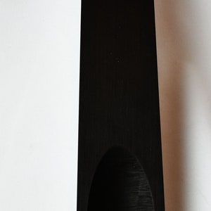 May include: A black wooden serving tray with a curved indentation in the center.
