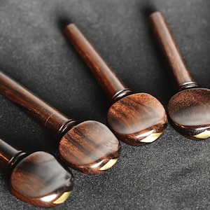 Juego de clavijas para violín de estilo suizo, hechas a mano en ébano de Ceilán o palisandro de la India con incrustaciones de rombos.