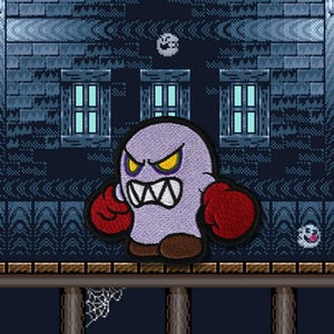 May include: Embroidered patch of a purple ghost character with angry yellow eyes, a wide white mouth, and red boxing gloves. The patch is set against a pixelated background of a haunted house.