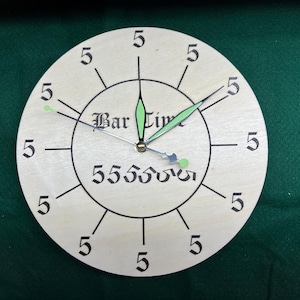May include: A round wooden clock with black numbers and hands. The clock face is white with the words "Bar Time" and "55550000" printed on it.