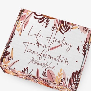 May include: A white box with a floral pattern and the text "Life Healing and Transformation" by "Malayaia Harnell".