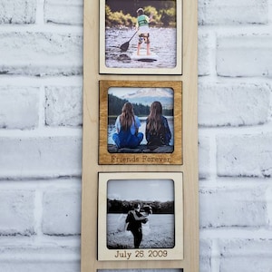 May include: A wooden ladder-style picture frame with three openings for photos. The top photo shows a person paddleboarding, the middle photo shows two people sitting on a rock by a lake with the text "Friends Forever" below the photo, and the bottom photo shows a couple in a field with the text "July 25, 2009" below the photo.