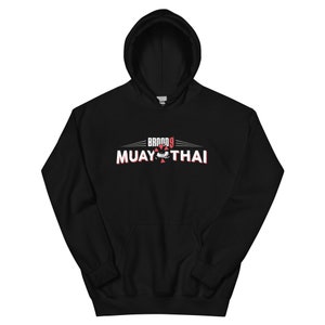 May include: Black hooded sweatshirt with a white graphic design that says "BROOD 9 MUAY THAI" with a red eye graphic.