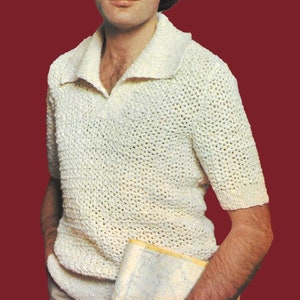 May include: A white crocheted short-sleeved shirt with a collared neckline. The shirt has a loose, open weave and is worn by a person with brown hair and sunglasses.