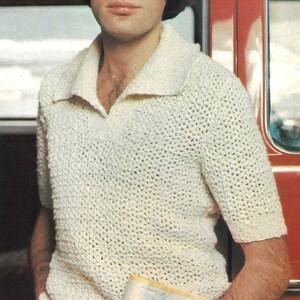 May include: A white crocheted short-sleeved shirt with a collared neckline. The shirt has a loose, open weave.