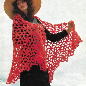 May include: A vibrant red crocheted shawl with a unique openwork design. The shawl is draped over the shoulders, showcasing its intricate pattern and textured appearance. The shawl's edges have a scalloped trim, adding a decorative touch.