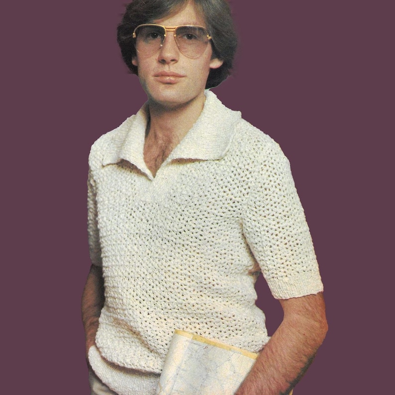 May include: A white crocheted short-sleeved shirt with a collared neckline. The shirt has a loose, open weave and is worn by a person with brown hair and a mustache.