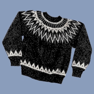 May include: Black sweater with a white geometric pattern around the neck and cuffs.