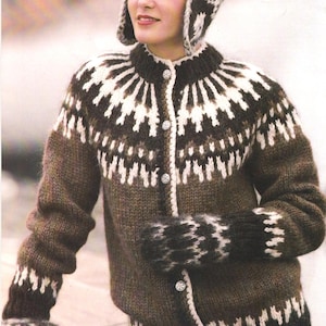 May include: A brown and white patterned knit cardigan with matching hat and mittens. The cardigan has a round collar and is buttoned down the front. The hat covers the ears and the mittens have a similar pattern. The knitwear is a warm, cozy style.