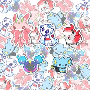 Puede incluir: Una colección de pegatinas de personajes de dibujos animados coloridos que representan a varias criaturas con detalles brillantes. Las pegatinas están impresas en papel blanco y tienen un acabado brillante.