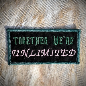 May include: A black patch with green and pink embroidered text that reads "Together We're Unlimited".