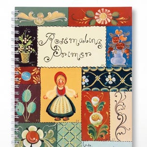 May include: A spiral-bound book titled Rosemaling Primer by Jo Sonja Jansen, dated 1976. The cover features a collage of painted panels displaying floral motifs, a central figure in traditional attire, and decorative scrollwork in red, green, and blue.