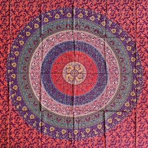 May include: A tapestry with a large, circular mandala design in shades of blue, purple, red, and yellow. The mandala is surrounded by a smaller floral pattern in shades of red and purple.