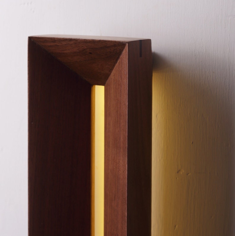 [Harmony] is a minimalist wood wall light, a linear wall lamp handmade of walnut wood, as wall art, home decor, bedroom decor. Also a perfect gift for him and gift for her.