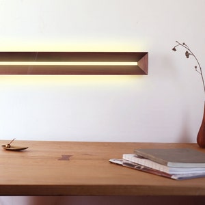 [Harmony] is a minimalist wood wall light, a linear wall lamp handmade of walnut wood, as wall art, home decor, bedroom decor. Also a perfect gift for him and gift for her.