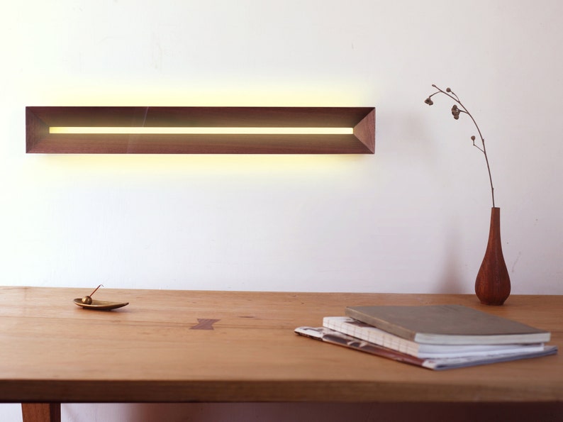 [Harmony] is a minimalist wood wall light, a linear wall lamp handmade of walnut wood, as wall art, home decor, bedroom decor. Also a perfect gift for him and gift for her.