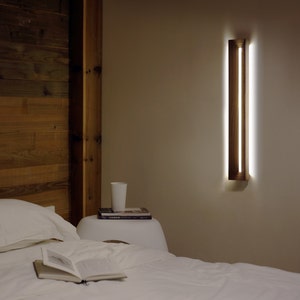 [Harmony] is a minimalist wood wall light, a linear wall lamp handmade of walnut wood, as wall art, home decor, bedroom decor. Also a perfect gift for him and gift for her.