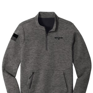 May include: A gray quarter-zip pullover with a black collar and a kangaroo pocket. The left sleeve features a black flag emblem. A black logo is on the chest. The zipper and pocket zippers are black.