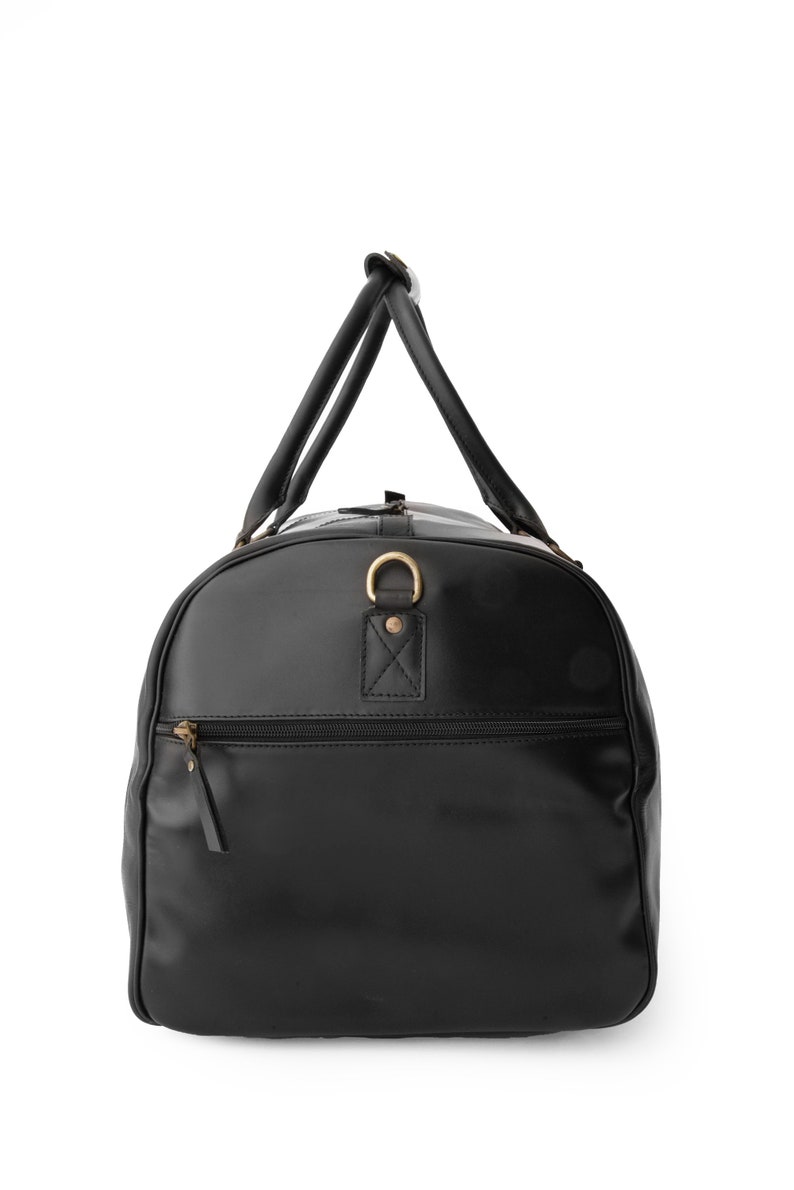 May include: A black leather duffel bag with a top handle and a zippered pocket on the front.