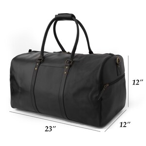 May include: Black leather duffel bag with two top handles and a zippered closure. The bag measures 23 inches wide, 12 inches tall, and 12 inches deep.