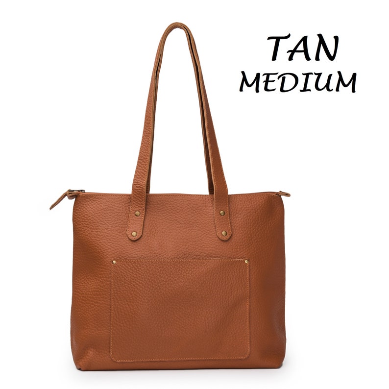 May include: Tan leather tote bag with a zipper closure and a front pocket.  TAN MEDIUM is written in black text on a white background.