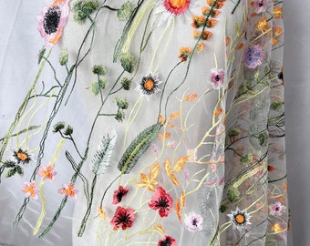 May include: White sheer fabric with embroidered floral designs in shades of green, pink, orange, and yellow.
