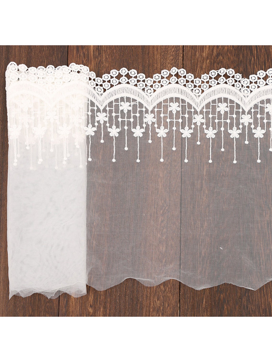 IVORY FLORAL DESIGN WITH CORD EMBROIDERY ON A MESH LACE-SOLD BY YARD.